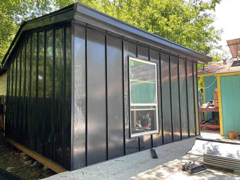 Black standing seam metal wall panels for Roof Inspection in Grayling