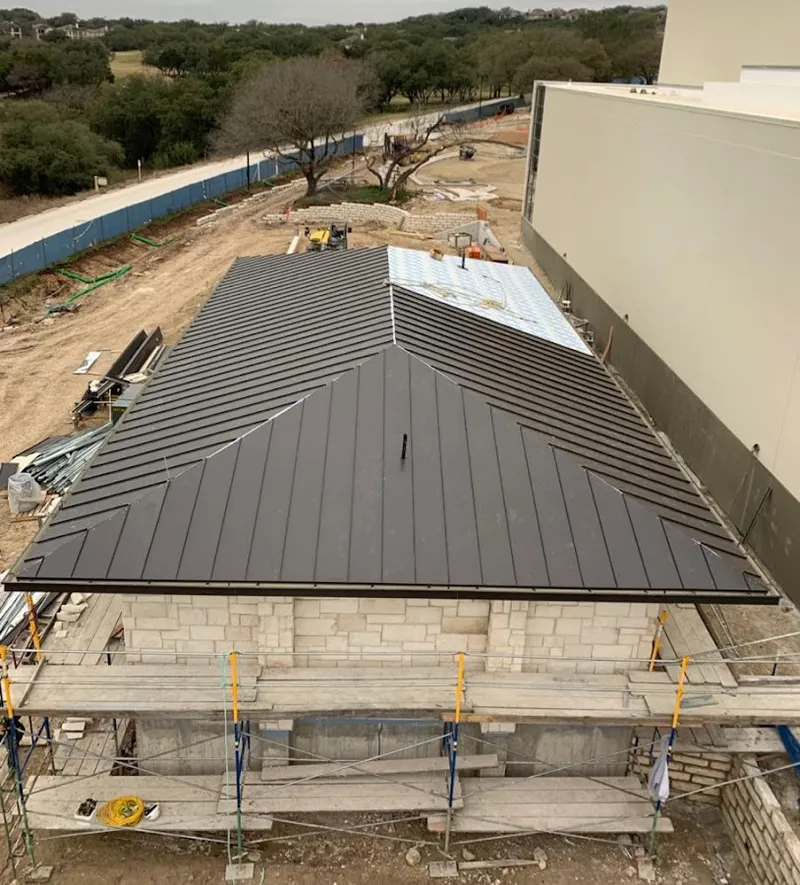 Metal roof new construction with scaffolding in Grayling
